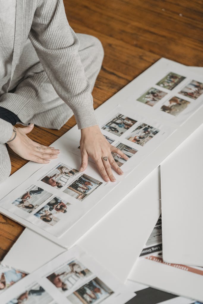 Crop person gluing family photos to poster