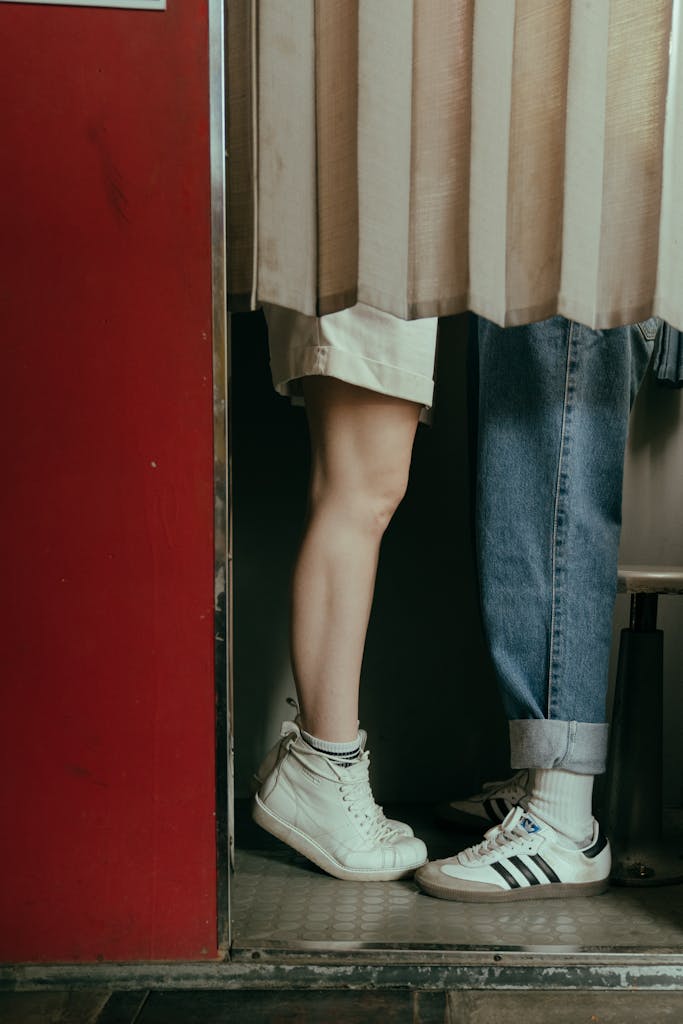 Person in Blue Denim Jeans and White Sneakers