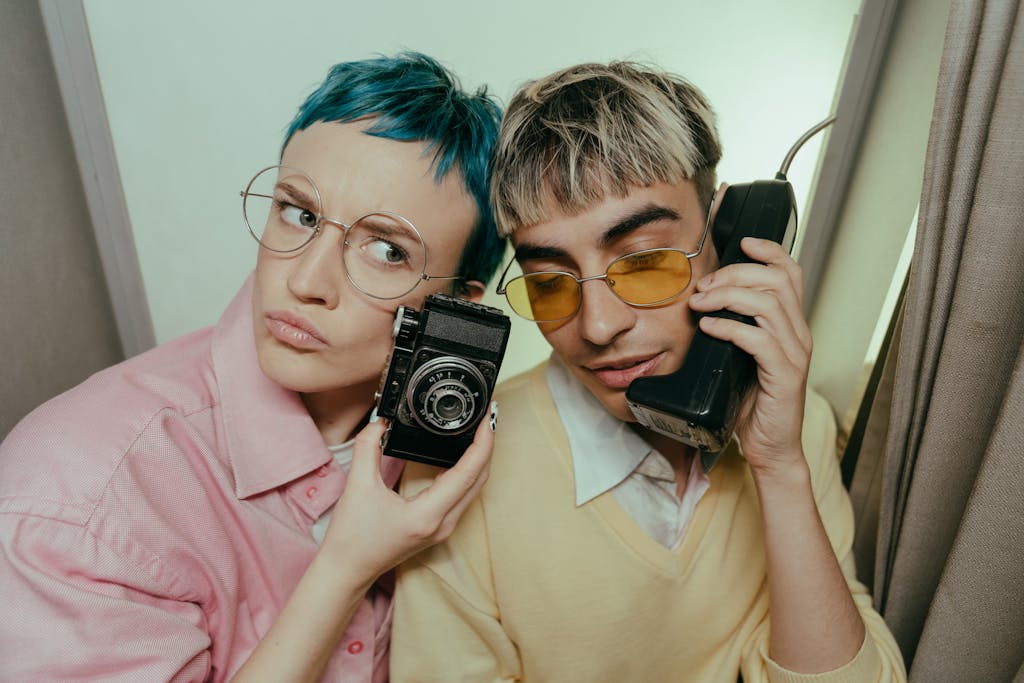 Woman in Pink Shirt Holding Black and Silver Camera